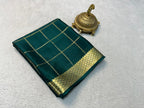 Pure Mysore Crepe Silk Saree with Zari & Elegant Blouse in deep green with gold checkered design and ornate zari border, displayed next to a decorative brass incense holder.